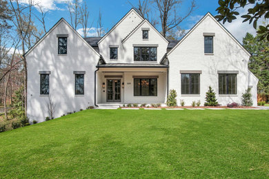 Inspiration for a large transitional white two-story brick exterior home remodel in Atlanta with a shingle roof