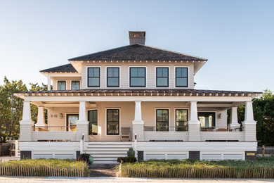 Mid-sized beige two-story wood and shingle house exterior idea in New York with a hip roof, a shingle roof and a black roof