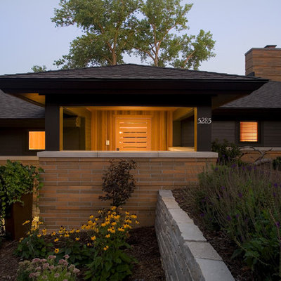 Inspiration for a large contemporary black one-story mixed siding exterior home remodel in Minneapolis with a hip roof and a shingle roof