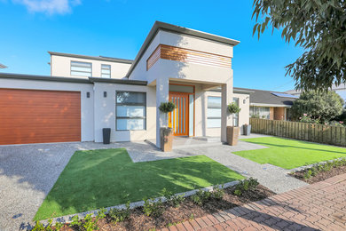 This is an example of a large and beige contemporary two floor detached house in Adelaide with a hip roof and a metal roof.