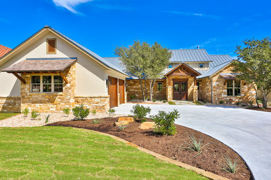 Mid-sized elegant beige one-story mixed siding exterior home photo in Austin with a metal roof