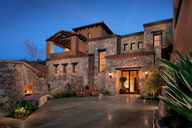 Mediterranean stone exterior home idea in Phoenix