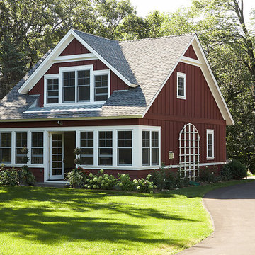 Front exterior of the little red sided cottage from the drive