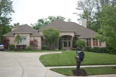 Example of a mid-sized classic brown two-story brick exterior home design in Indianapolis