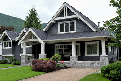 Large craftsman blue two-story mixed siding exterior home idea in Vancouver with a shingle roof