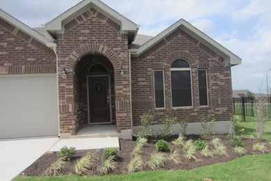 Inspiration for a mid-sized southwestern brown two-story brick house exterior remodel in Austin