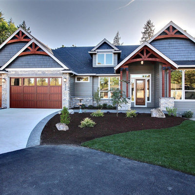 Inspiration for a large craftsman black split-level mixed siding house exterior remodel in Portland with a shingle roof and a hip roof