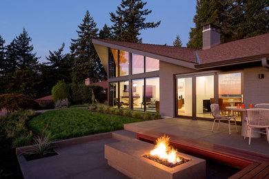 Inspiration for a mid-sized mid-century modern gray one-story brick house exterior remodel in Portland with a shingle roof and a hip roof