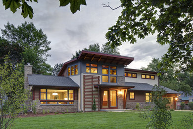 Inspiration for a large 1950s gray two-story mixed siding exterior home remodel in Milwaukee