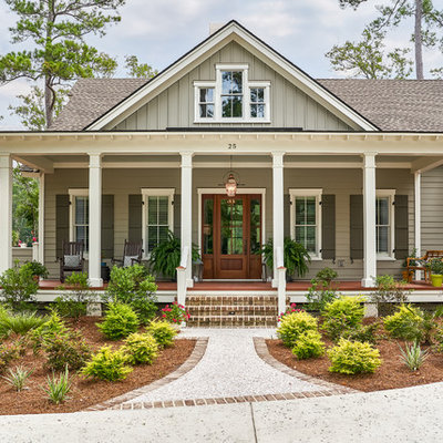 Example of a beach style gray two-story wood exterior home design in Charleston with a shingle roof