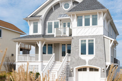 Mid-sized beach style gray three-story mixed siding exterior home photo in New York with a shingle roof
