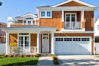 Large and brown coastal two floor detached house in Los Angeles with wood cladding, a pitched roof and a shingle roof.