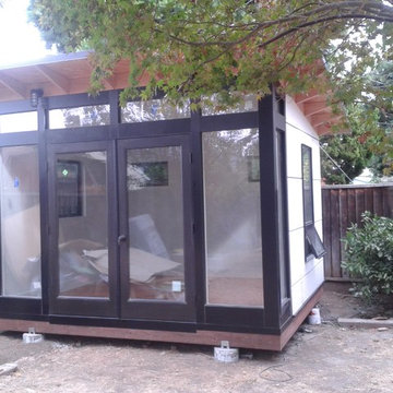 Full glass in front with white hardy board siding