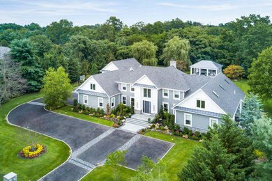 Huge elegant gray two-story mixed siding exterior home photo in New York with a shingle roof