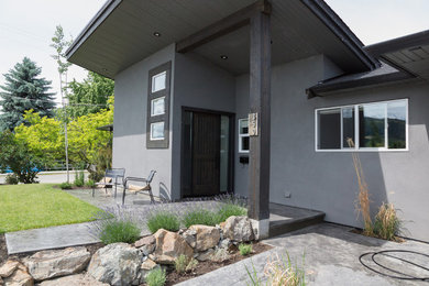 Inspiration for a mid-sized contemporary gray two-story stucco exterior home remodel in Other