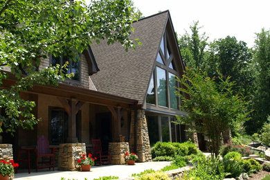 Huge craftsman two-story stone exterior home idea in Other with a shingle roof