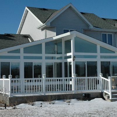 Inspiration for a large timeless white two-story wood exterior home remodel in Other with a shingle roof