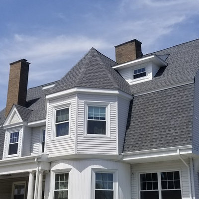 Mid-sized traditional white two-story vinyl house exterior idea in Providence with a gambrel roof and a shingle roof