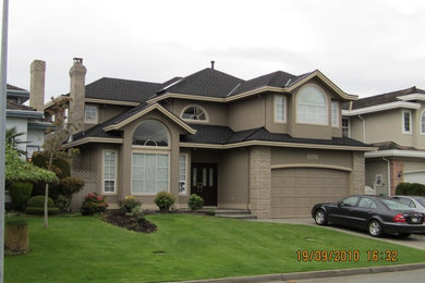 Photo of a beige contemporary two floor render house exterior in Vancouver.