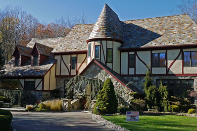Example of a large beige three-story concrete fiberboard gable roof design in New York