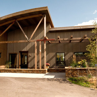 Large urban gray one-story mixed siding exterior home photo in Other