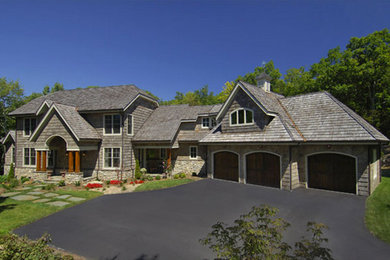 Large transitional brown one-story stone exterior home idea in Charlotte