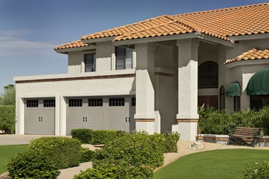 Inspiration for a timeless beige two-story stucco exterior home remodel in Phoenix