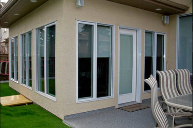 Example of a transitional exterior home design in Calgary