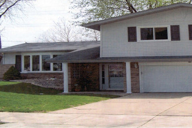 Photo of a medium sized and white traditional two floor house exterior in Chicago with mixed cladding.