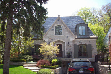 Inspiration for a mid-sized beige two-story stone exterior home remodel in Toronto