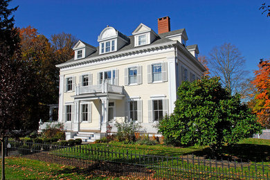 This is an example of a large and beige traditional detached house in New York with three floors, wood cladding, a pitched roof and a shingle roof.
