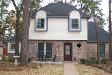 Mid-sized two-story mixed siding exterior home photo in Houston with a clipped gable roof