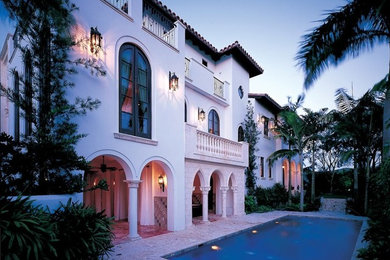 Inspiration for a huge beige three-story exterior home remodel in Miami
