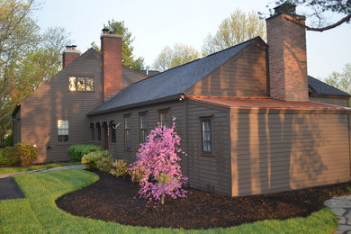 Inspiration for a large timeless brown two-story wood exterior home remodel in New York with a shingle roof