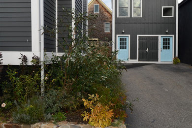 Example of a mid-sized transitional black two-story wood exterior home design in Portland Maine