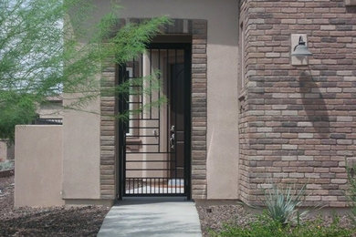 Design ideas for a large and brown two floor house exterior in Phoenix with stone cladding.