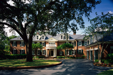 Example of a huge classic two-story brick exterior home design in Jacksonville