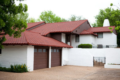 Inspiration for a large southwestern white two-story mixed siding exterior home remodel in Oklahoma City with a hip roof