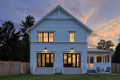 Farmhouse white two-story concrete fiberboard exterior home idea in DC Metro with a shingle roof