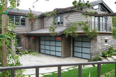 This is an example of a large and beige classic two floor detached house in Los Angeles with concrete fibreboard cladding, a pitched roof and a shingle roof.