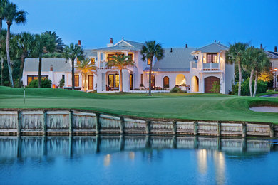 Example of a huge island style white exterior home design in Jacksonville