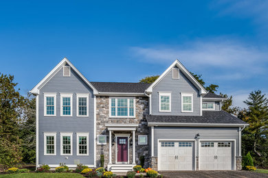 Inspiration for a timeless blue two-story vinyl exterior home remodel in Bridgeport with a shingle roof