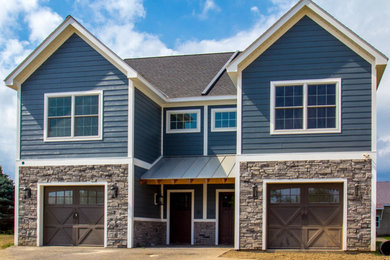 Inspiration for a large timeless blue two-story mixed siding exterior home remodel in New York with a shingle roof