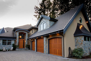 Inspiration for a huge timeless beige two-story stucco exterior home remodel in Vancouver