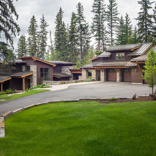 Example of a mountain style brown two-story wood exterior home design in Seattle with a shed roof
