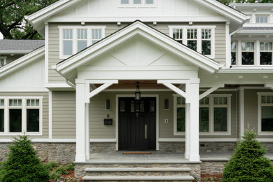 Inspiration for a large transitional green two-story mixed siding house exterior remodel in New York