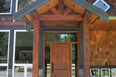 Large elegant brown two-story wood gable roof photo in Vancouver with a shingle roof