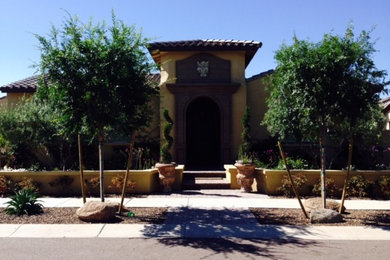 Example of a large trendy beige one-story exterior home design in Phoenix