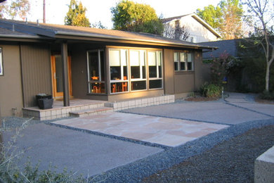 Large and brown midcentury bungalow house exterior in Orange County with mixed cladding.