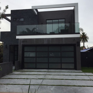 Large minimalist black two-story mixed siding exterior home photo in Los Angeles with a mixed material roof